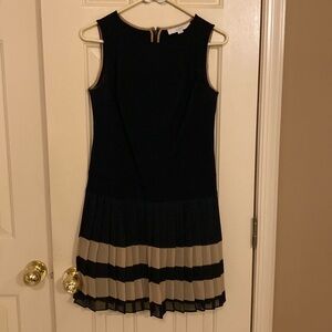 Black sleeveless dress with pleated black and tan skirt at bottom. Loft size 2